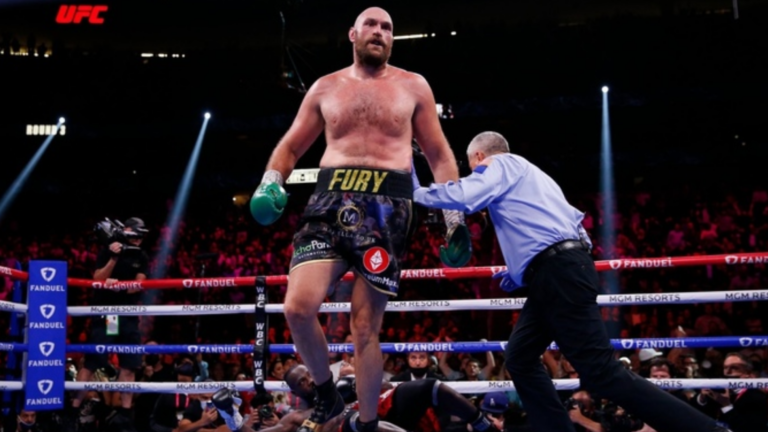 Heavyweight boxer Tyson Fury celebrating a victory, announcing his April 2026 comeback fight against Arslanbek Makhmudov to be streamed on Netflix.