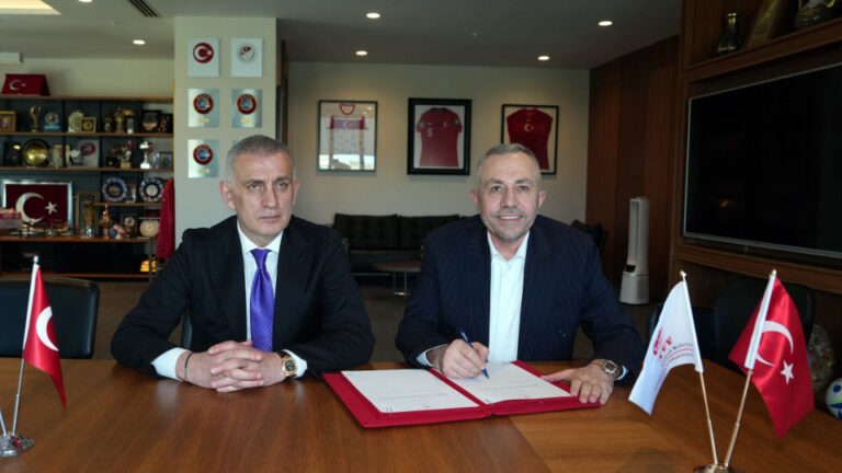 TFF President HacÄ±osmanoÄŸlu and Hulusi OÄŸuz shaking hands at the sponsorship signing ceremony at Hasan DoÄŸan Facilities.