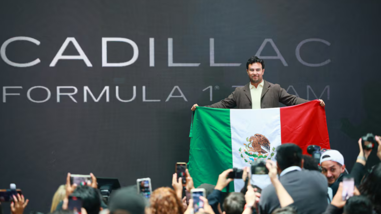 Sergio Perez standing with Cadillac team leaders following the announcement of the América Móvil partnership.