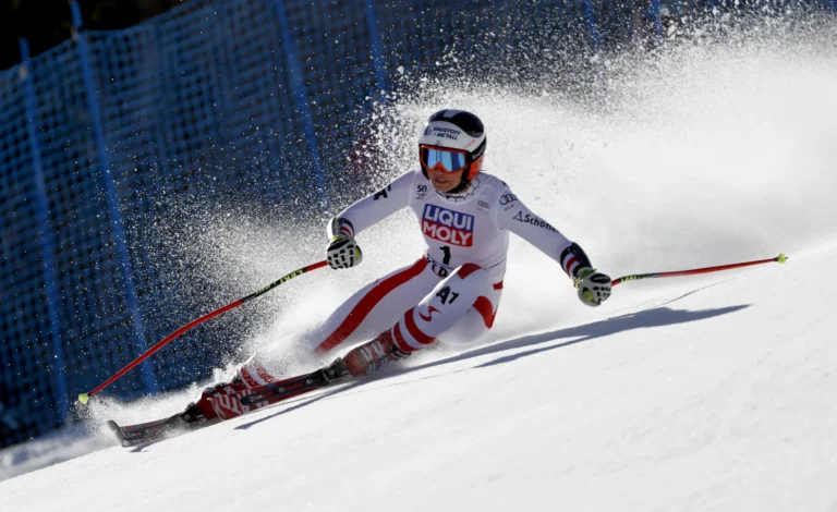Professional skier in action during a DSV World Cup event with ARD and ZDF broadcasting logos in the background.