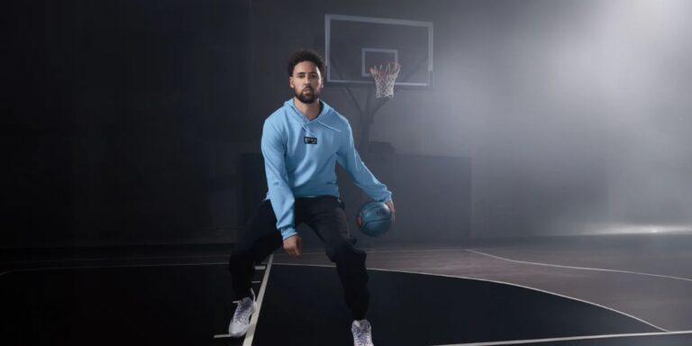 Klay Thompson holding the silver KT11 "Make It Forever" sneaker at the Anta Beverly Hills store opening.