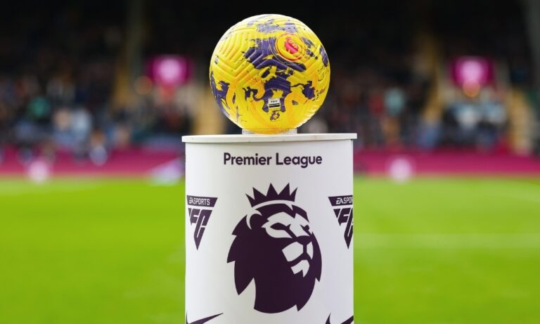 Premier League logo and pitch-side advertising boards at a stadium