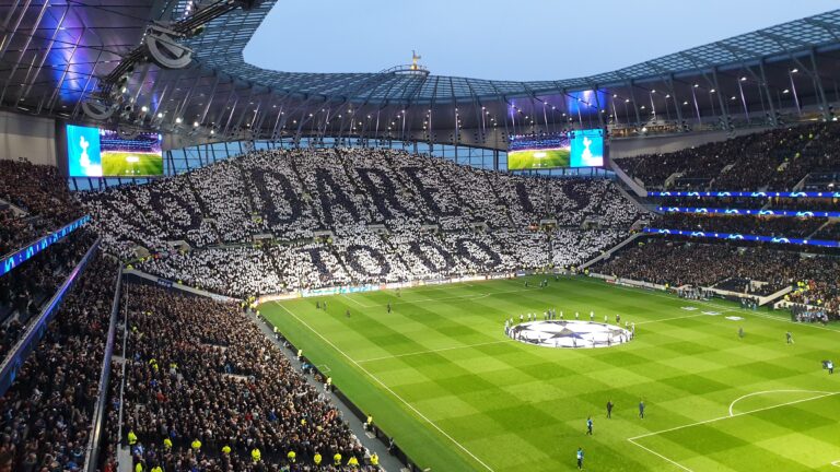 Fans outside the Tottenham Hotspur Stadium holding 'Stop Exploiting Loyalty' banners.