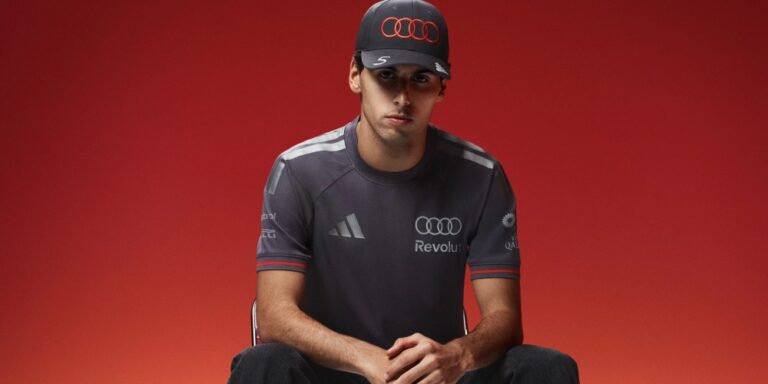 Nico HÃ¼lkenberg and Gabriel Bortoleto wearing the grey and red adidas Audi F1 2026 teamwear.