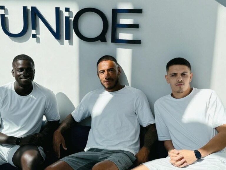Interior view of UNIQE Club in Lyon Part-Dieu featuring high-end training equipment and the boutique studio branding.