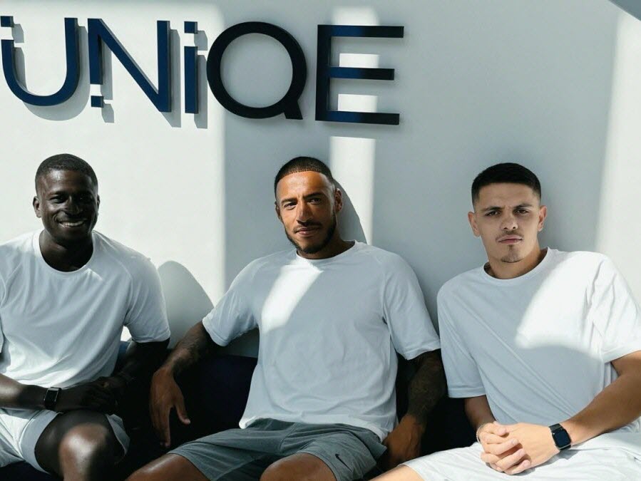 Interior view of UNIQE Club in Lyon Part-Dieu featuring high-end training equipment and the boutique studio branding.