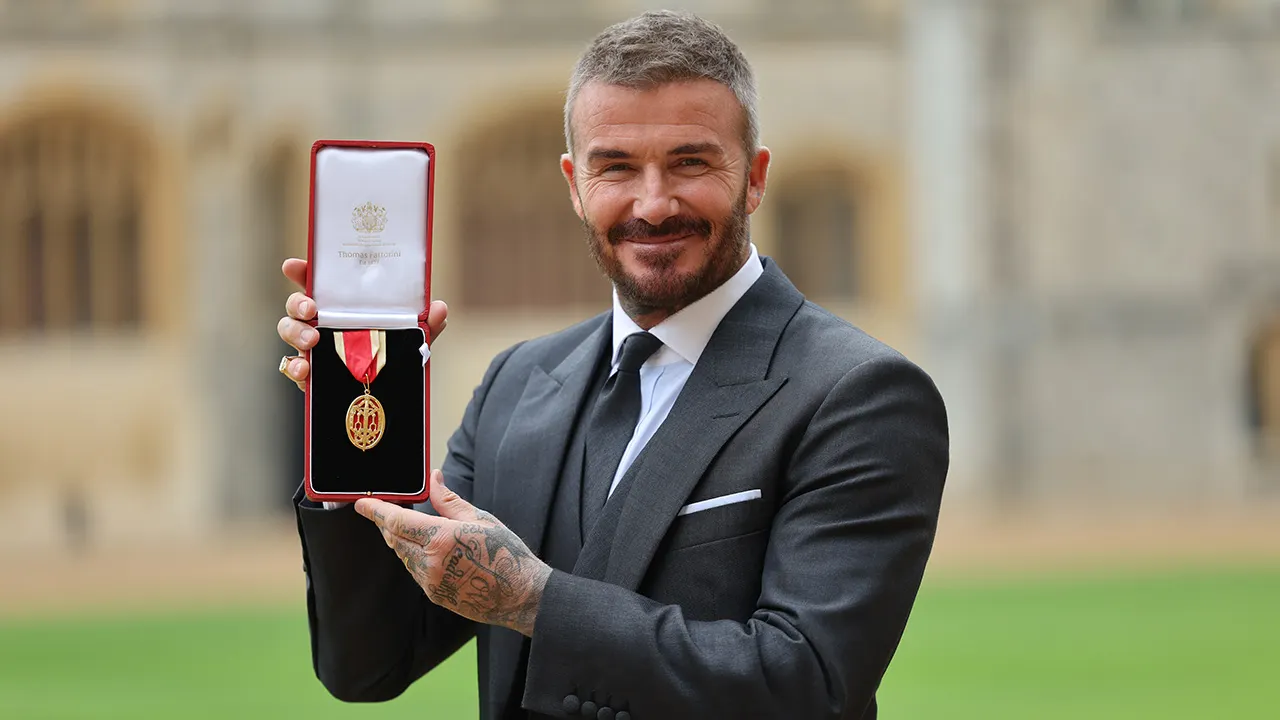 David Beckham holding an exclusive Topps Chrome trading card following his new partnership with Fanatics.