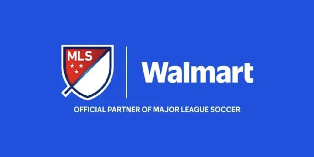 A high-energy soccer match at a crowded stadium with a digital overlay of the 'Walmart Saturday Showdown' logo. A side-by-side view shows a traditional broadcast angle next to a dynamic, close-up 'Shot on iPhone' perspective of a player celebrating.