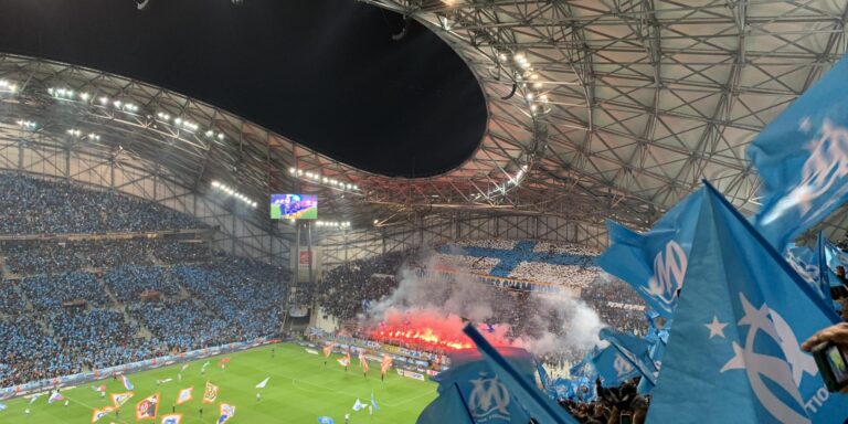 Promotional poster for 'La Prise du Vel' featuring Les Marseillaises players and the Orange VÃ©lodrome stadium.