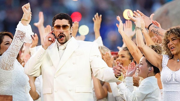 Bad Bunny performing at the Super Bowl LX halftime show in front of a massive crowd.