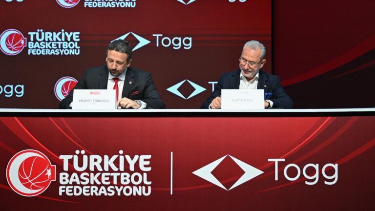 Hidayet TÃ¼rkoÄŸlu and Fuat TosyalÄ± presenting a national basketball jersey in front of a Togg T10F.