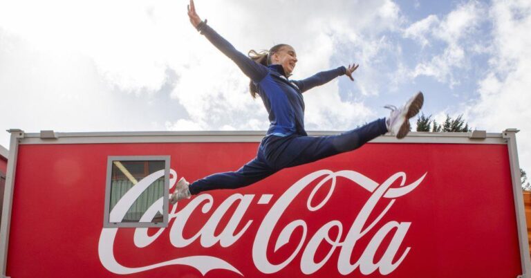 Coca-Cola branding displayed at a Commonwealth Games venue with beverages supplied for Glasgow 2026