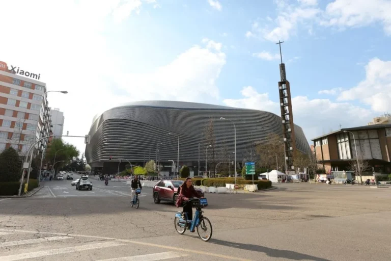 Santiago BernabÃ©u stadium exterior with partial LED facade lighting during ongoing renovation works